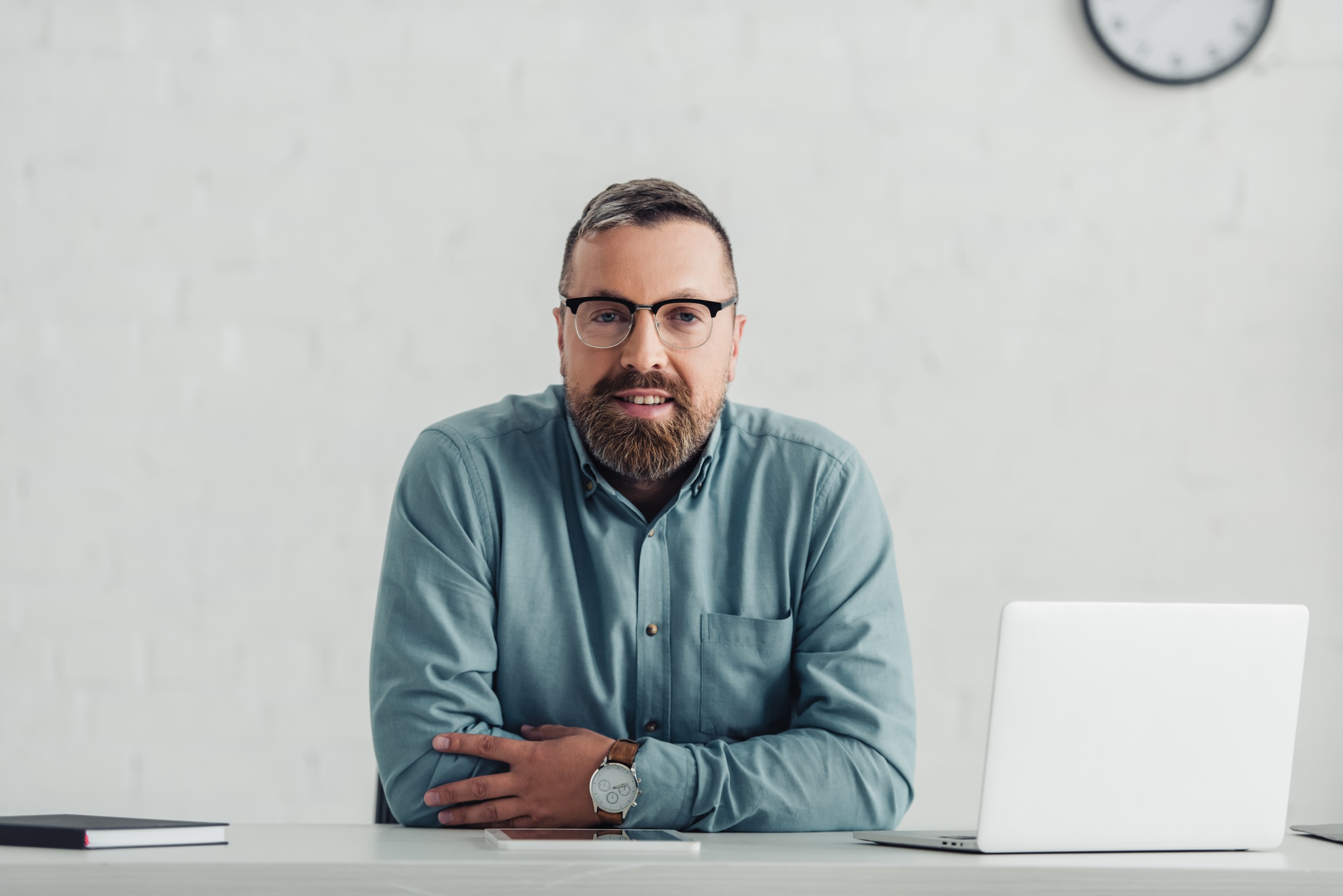 handsome businessman in shirt and glasses looking at camera in office Handsome Businessman In Shirt And Glasses Looking SBQLVQU